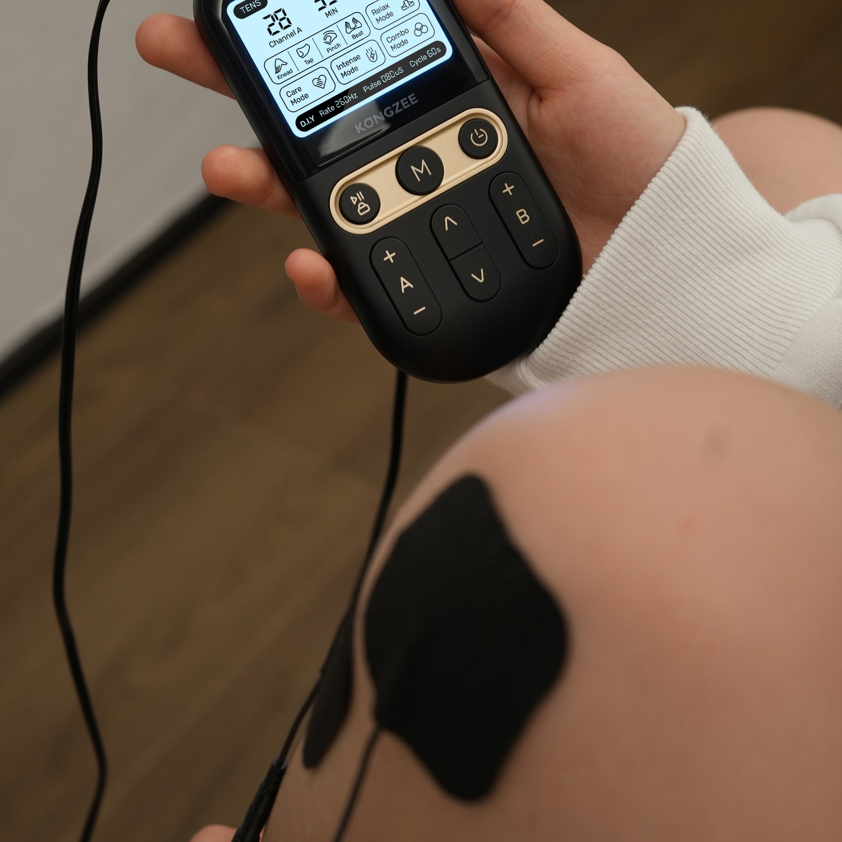 Adult using gentle movement to manage muscle tension while learning about TENS and EMS