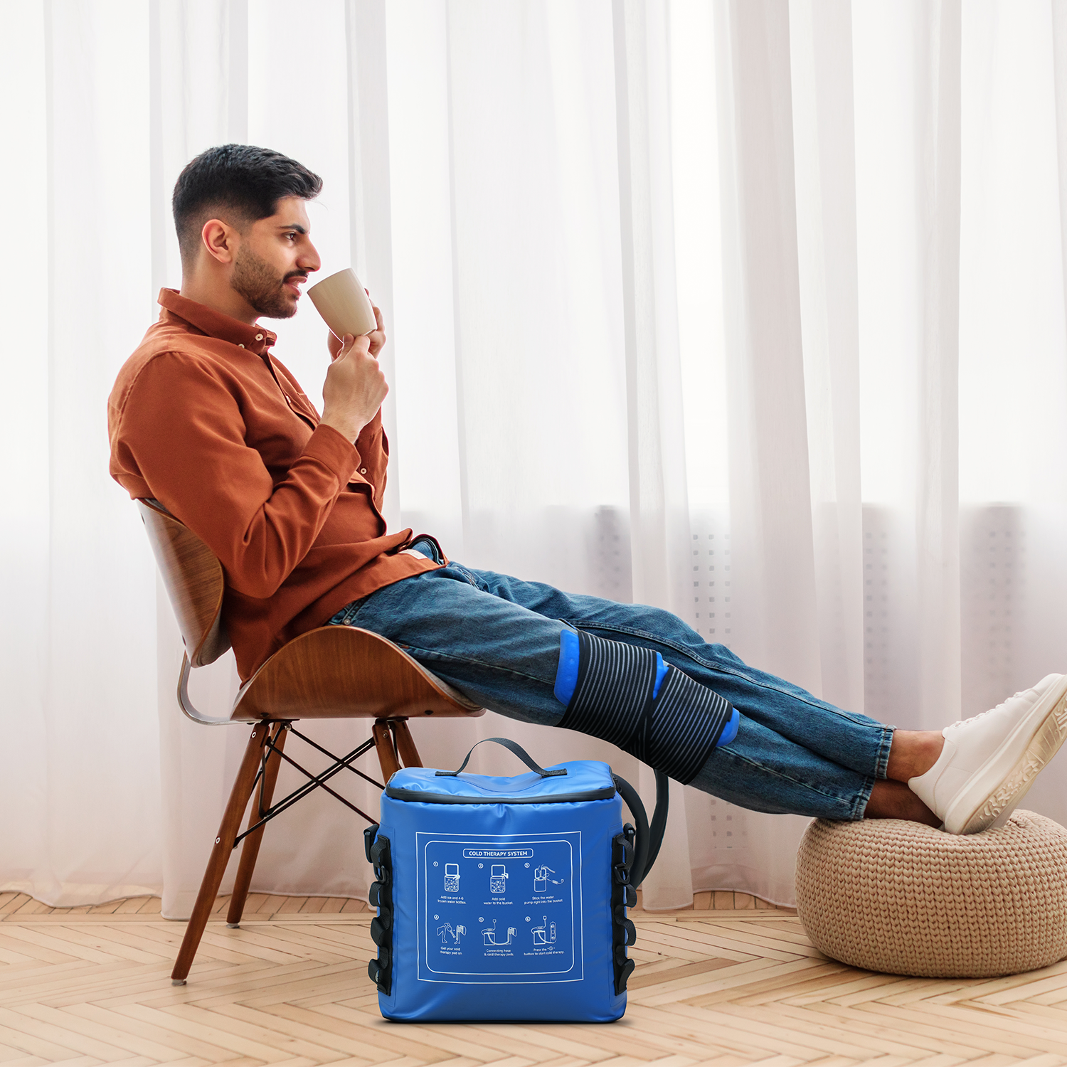 Person using a circulating cold therapy wrap during home recovery
